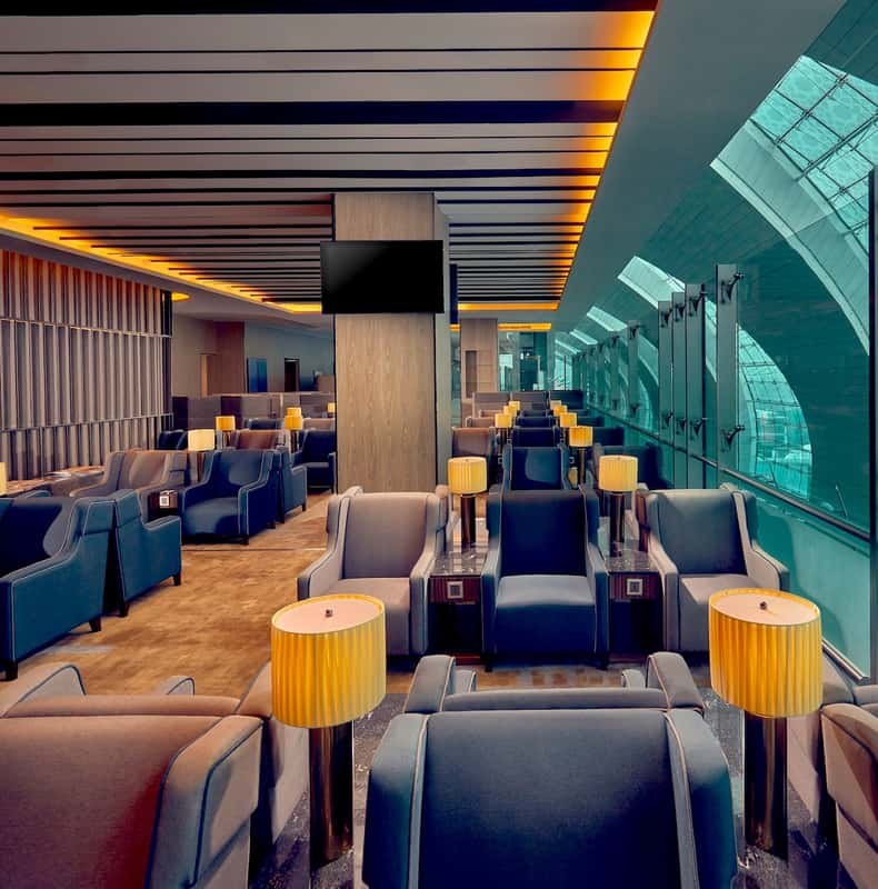 Seating and reading lamps inside a premium lounge at Dubai International Airport