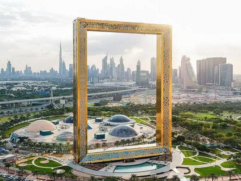 The Dubai Frame from above, with the Downtown skyline on one side and Zabeel Park on the other